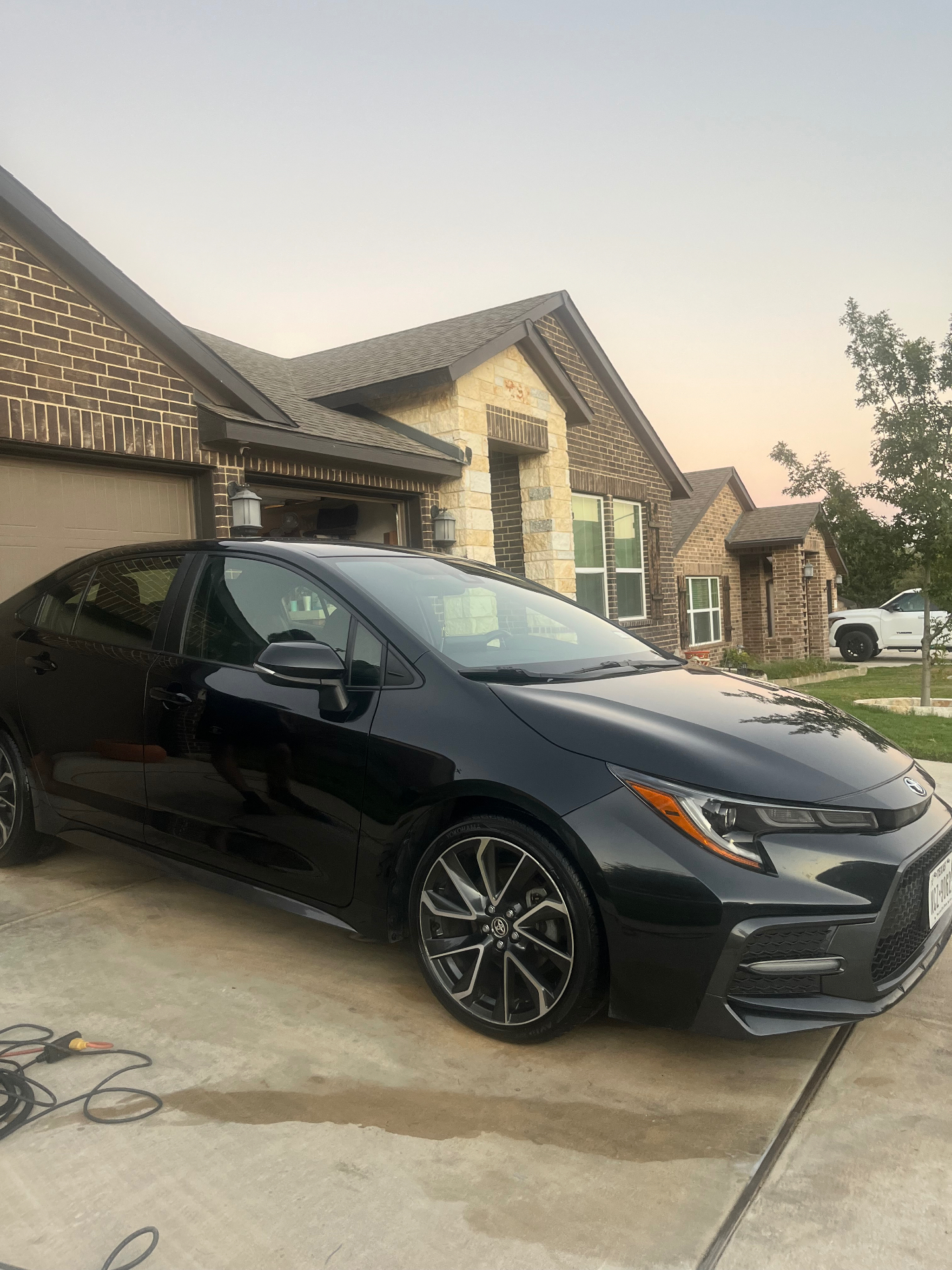 Same black Toyota Corolla with a deep gloss finish after detailing