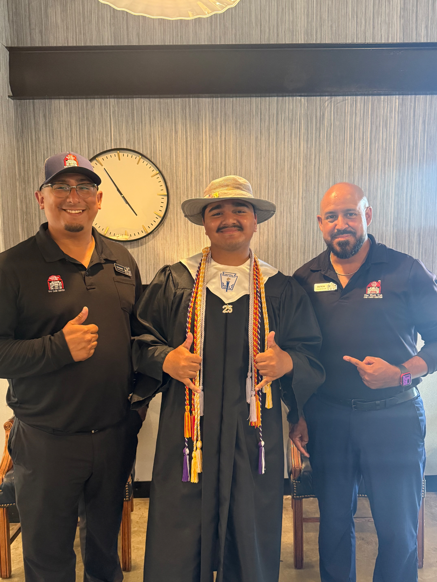 Eduardo Gonzales at his high school graduation with WashTub coworkers
