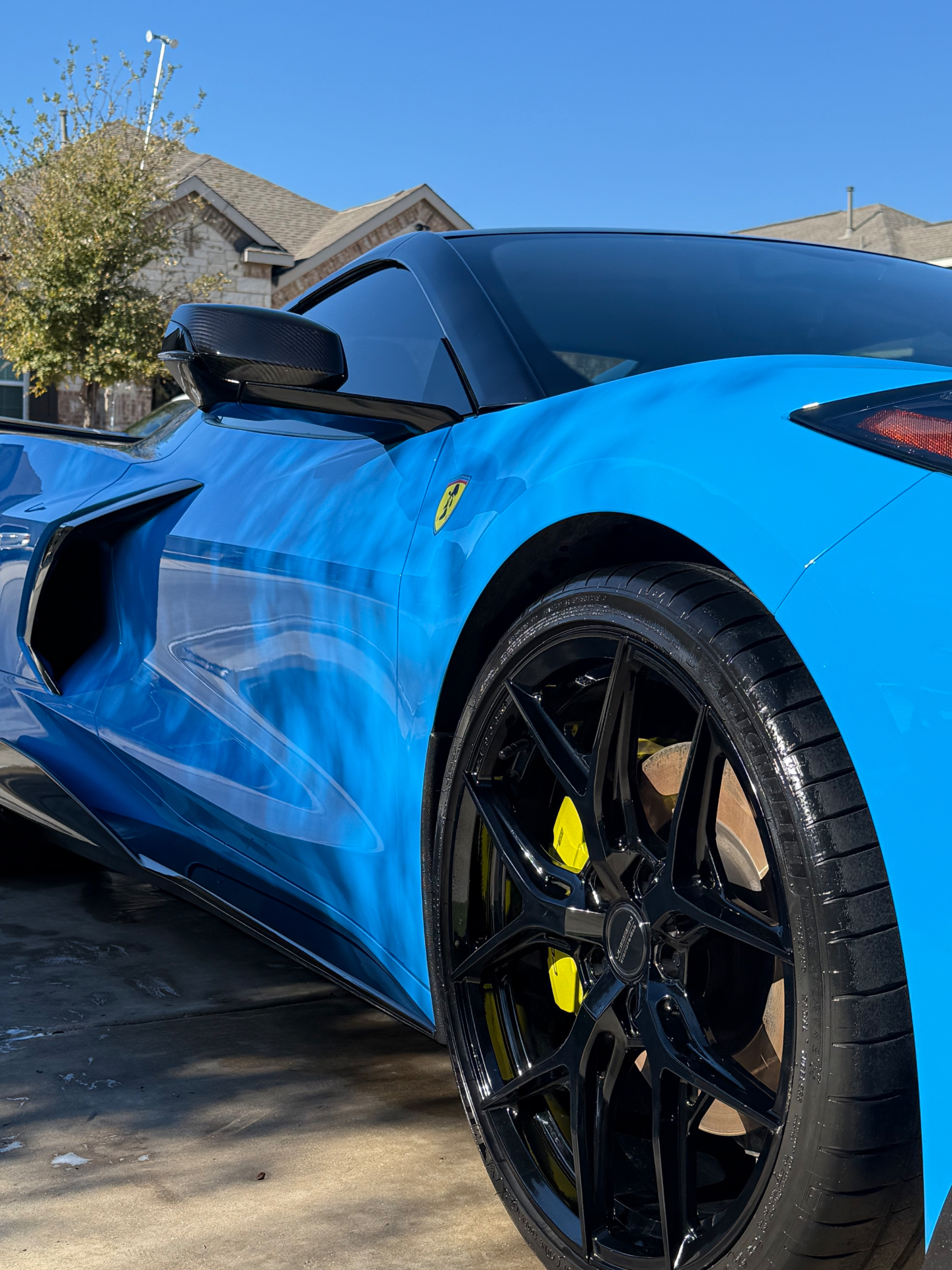 Blue supercar with mirror-gloss paint and polished black wheels